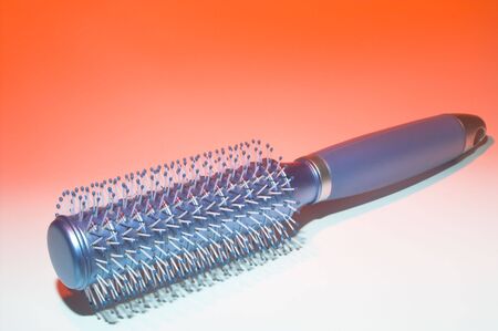 A hairbrush ready to beautify a woman's hair.の写真素材
