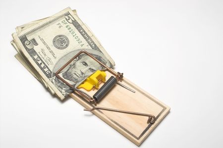 Money trapped in a mousetrap. Financial concept.の写真素材