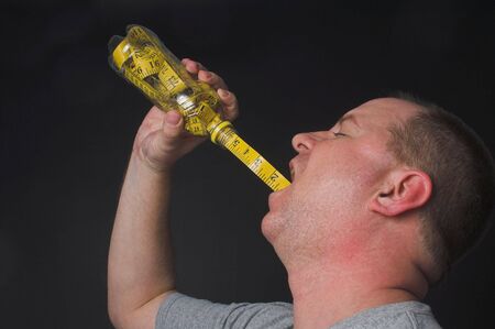 A man enjoying a beverage. Diet drink concept.