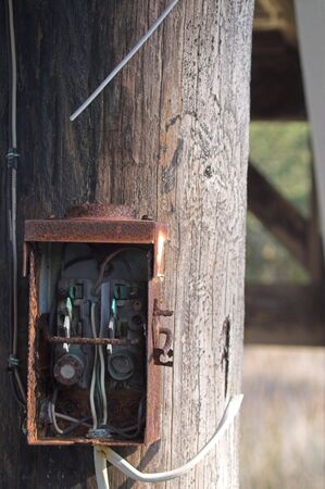 An old electrical box on a telephone pole.の写真素材