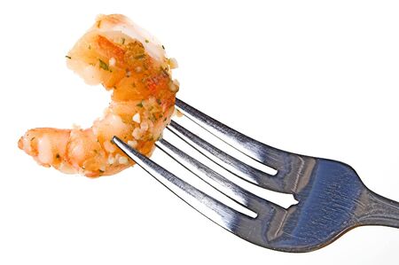 A fork full of delicious gourmet garlic shrimp..の写真素材