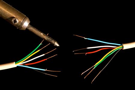 Frayed electrical wires and a soldering iron.