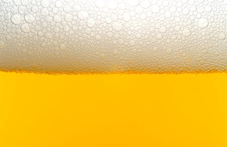 A close-up image of a beer with a foam head.