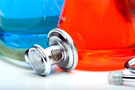 A medical stethoscope and laboratory research beakers.
