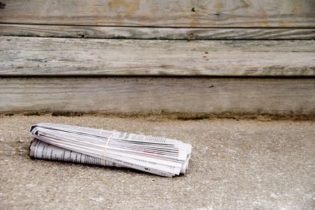 A freshly delivered Sunday morning early edition newspaper.の写真素材