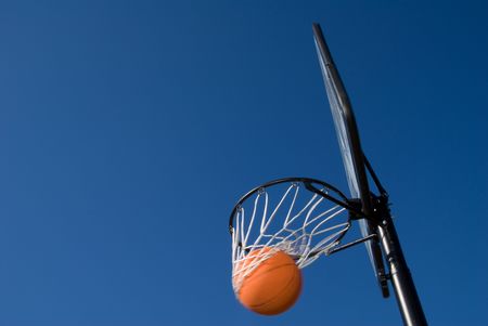 A basketball and goal waiting for a game to start.の写真素材