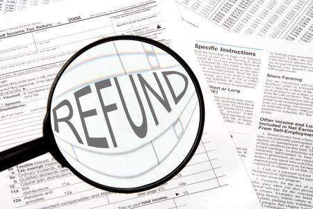 Federal tax forms under a magnifying glass.の写真素材