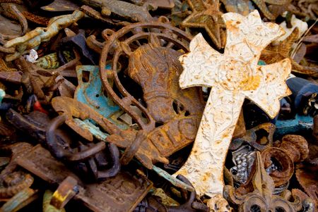 A Christian Cross in a pile of scrap metal.の写真素材