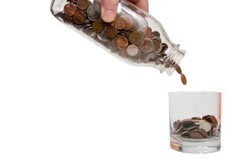 A person pouring money into a glass.の写真素材