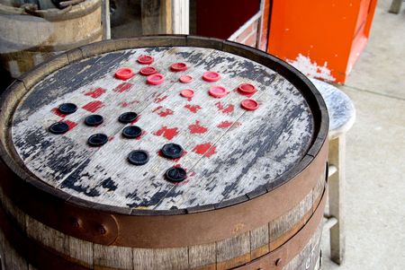 Checkers on a board made from an old barrel.の写真素材
