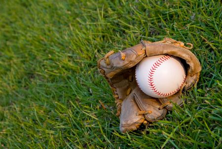 A baseball and glove in the evening sun.の写真素材