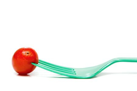 A cherry tomato on a plastic fork.
