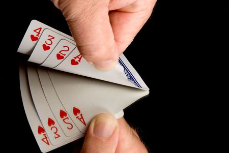 A person peaking at thier hand of cards.の写真素材