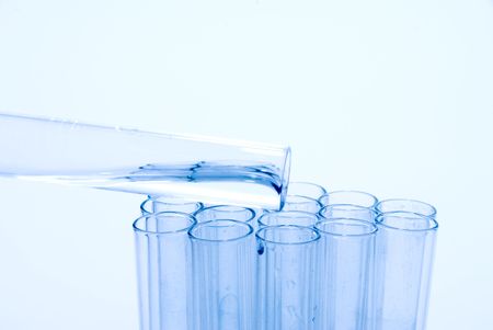 A series of test tubes being used in scientific experiments.の写真素材