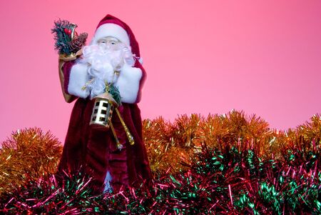 A Santa Claus figure surrounded by Chrsitmas garland.の写真素材