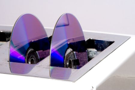 A couple of compact discs in a toaster.