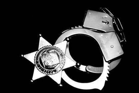 A sheriffs badge and a pair of handcuffs