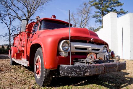An old vintage antique firetruck ready for actionの写真素材