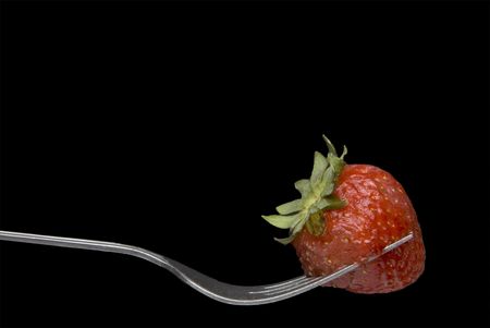 A fresh and delicious Strawberry on a Forkの写真素材