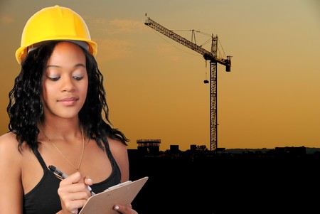 A giant crane at a construction site at dusk.の写真素材