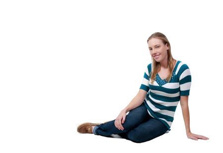 A beautiful young woman sitting on the floorの写真素材