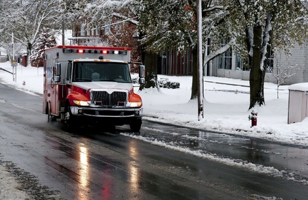 An ambulance driving to an emergency on a snow day