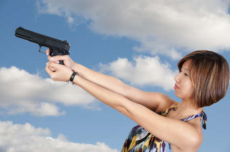 A beautiful Asian female police detective woman on the job with a gun