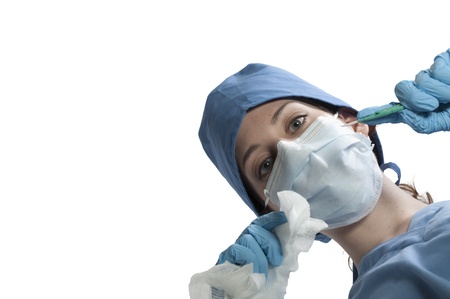 A beautiful young woman surgeon performing surgeryの写真素材