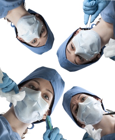 A beautiful young woman surgeon performing surgeryの写真素材