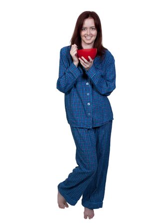 A beautiful woman eating food from a bowlの写真素材