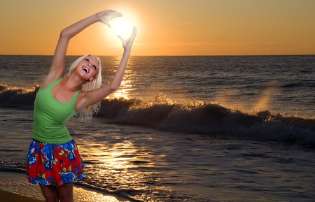 A beautiful young woman hanging the sunsetの写真素材