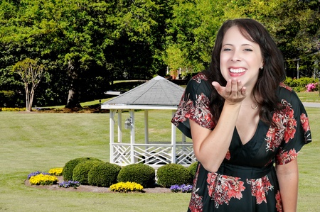 A beautiful young woman blowing a kissの写真素材