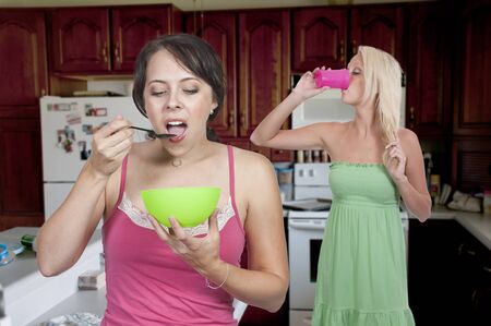 A couple of beautiful young woman having breakfast in the morningの写真素材