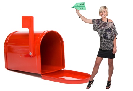 A woman throwing a paper airplane that says I Love Youの写真素材