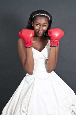 Black African American Woman Bride in a wedding dress with boxing glovesの写真素材
