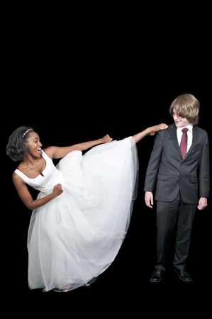 Black African American woman kicking a caucasian man.の写真素材