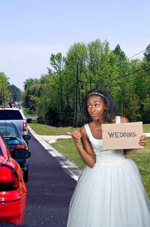 Black African Americal Woman Bride in a wedding dress hitching a ride to the ceremonyの写真素材