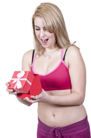 A beautiful young woman holding a Valentines Day heartの写真素材