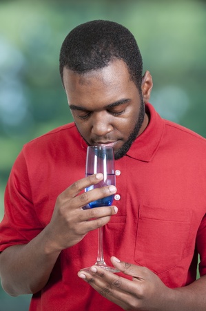 Black African American man holding a wine glass の写真素材