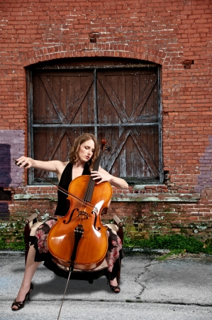 Beautiful woman cellist with her cello musical instrumentの写真素材