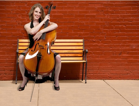 Beautiful woman cellist with her cello musical instrument