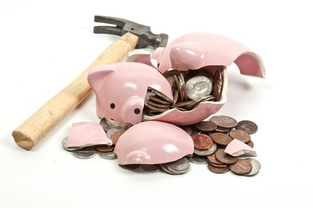 Broken piggy bank filled with loose change Broken piggy bank filled with loose change