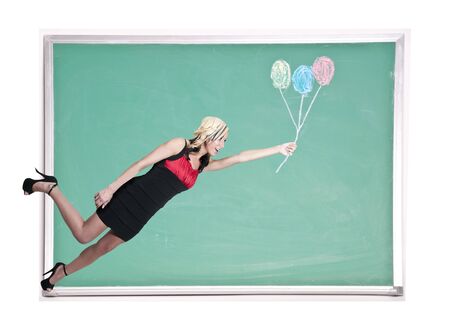 A beautiful young woman floating with balloons on a chalkboard