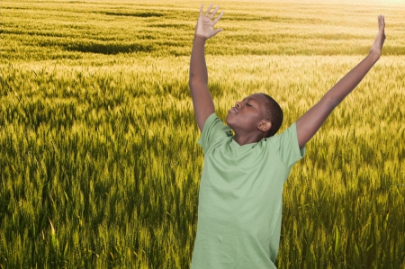 Handsome young African American teenager with allergies in a fieldの写真素材