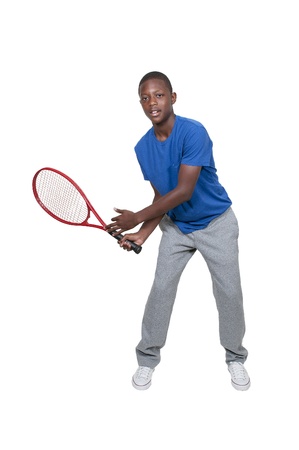 Handsome young black African American teenage man playing tennisの写真素材