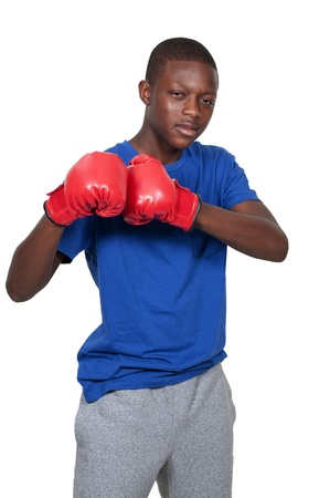 Black African American teenage boy athletic boxer with boxing gloves