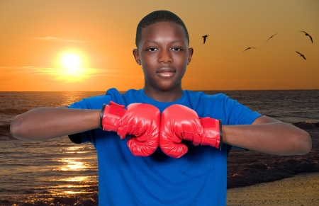 Black African American teenage boy athletic boxer with boxing glovesの写真素材