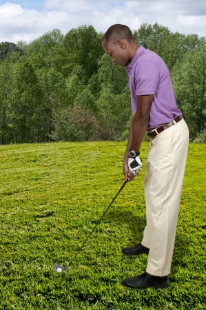 Handsome man playing a round of the sport known as golfの写真素材