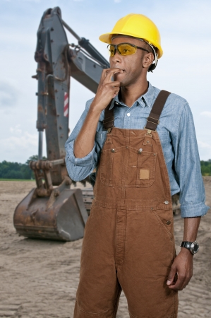 Handsome man construction worker signaling by whistlingの写真素材