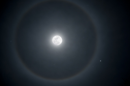 Full moon with a ring of ice in the atmosphereの写真素材